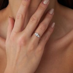 a woman's hand with a diamond ring on it