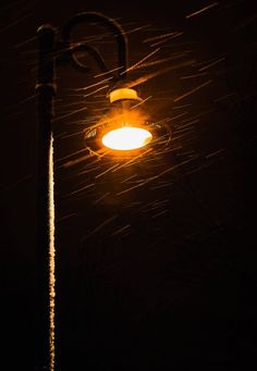 a street light in the rain at night