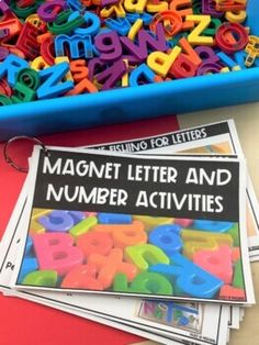 the magnet letter and number activities are in front of a blue tray with black letters