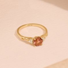 Crafted in 14k Solid Gold, our Braided Padparadscha Engagement Ring is a vintage-inspired masterpiece. The captivating Oranged-hued gemstone, intricately braided band, and delicate accents create a unique and elegant piece. Whether for an engagement or an anniversary, this ring symbolizes enduring love and timeless beauty. Make her heart skip a beat with this exquisite ring that's as extraordinary as she is. Ring Details * Gold Kt: 10k 14k 18k Solid Gold * Band Options; Yellow Gold, White Gold, Rose Gold * Band Width: 1.60 mm * Top Width: 6.00 mm * Thickness: 1.40 mm * Gemstone: Lab Created Padparadscha - Round 6mm * Gemstone: Diamond * Gem Color and Clarity: G Colour SI Clarity * Diamond CTW: 0.12ctw  🦄 Find out more about my shop at: https://etsy.me/3uTPmyQ 💅 Go Directly to My Sections Gold Round Engagement Ring, Padparadscha Sapphire Ring, Pink Gemstone Ring, Round Engagement Ring, Ring Crystal, Padparadscha Sapphire, Solid Gold Band, Round Engagement Rings, Engagement Ring Shapes