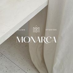 the monogrammed logo for monarca salon sits under a white countertop