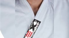 a man wearing a white belt with an american flag design on the front and side