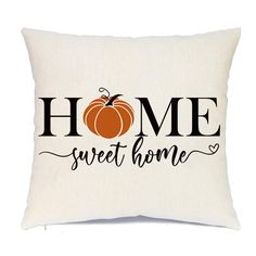 a pillow that says home sweet home with a pumpkin on the front and black lettering