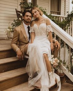 a bride and groom are sitting on the steps