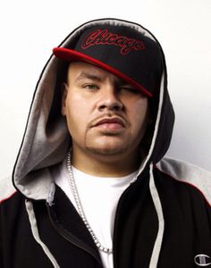 a man in a black and grey hoodie with a red cap on his head