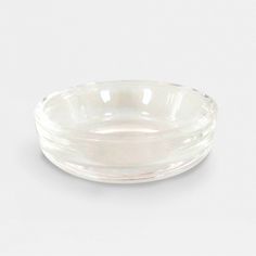 a clear glass bowl on a white background