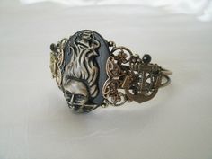 This beautiful antique brass filigree cuff bracelet has a siren of the sea cameo with antique brass filigree accents on the sides, ships wheel and anchor accents. Adjustable. Handmade Victorian Brass Bracelets, Steampunk Style Bracelet Jewelry Gift, Handmade Steampunk Bracelets As Gift, Handmade Steampunk Bracelets For Gift, Gothic Gold Bracelets For Gifts, Adjustable Bronze Steampunk Jewelry, Gold Gothic Bracelets For Gifts, Gold Gothic Bracelet For Gift, Antique Adjustable Hand Cast Jewelry