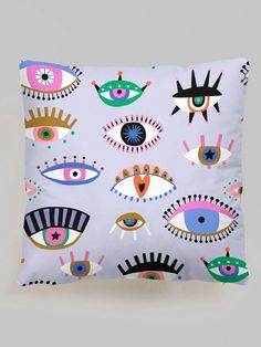 an eye pillow is shown on a gray background with colorful eyes and stars in the middle