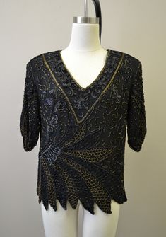 "Description: 1980s black sequin and bead blouse. Some of the sequins have a matte finish. Scalloped edge on hem and sleeve cuffs. Padded shoulders and a V-neck. Silk exterior with rayon lining. Made in India. Condition: In great condition, with no holes or stains. Designer: Mark and John II Stated Size: Large Measurements: Armpit to armpit: 20\" Shoulder to shoulder: 19\" Sleeve length: 14\" Overall length: 24\" Waist: 38\" ---> If you need an order shipped by a particular date or shipped vi V-neck Sequin Blouse For Evening, Embellished V-neck Tops For Party Season, Vintage V-neck Blouse For Party, Vintage V-neck Party Blouse, Vintage V-neck Blouse For Evening, Fitted Beaded V-neck Blouse, Formal V-neck Top With Sequins, Formal V-neck Sequin Tops, Elegant Beaded V-neck Tops