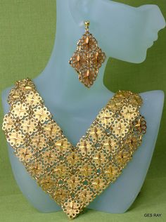 "Fabulous Etruscan Style gold plated filigree panel jewelry set/ parure: necklace, bracelet, clip on earrings and pierced earrings. The bracelet is 7 1/4\"\" long and 1 1/4\" wide and it has a flip over clasp. It has a 2\" long secure chain with the spring clasp The necklace , clip on earrings and the bracelet are marked \" D'Orlan\". The regular earrings are not marked. The inside necklace measurement is 17 inches and 5/8\" wide at the widest point.The middle ornamental piece is 6\" long and 3\ Elegant Gold-tone Jewelry With Filigree, Elegant Gold-tone Filigree Jewelry, Gold-tone Pierced Jewelry For Wedding, Gold Plated Filigree Jewelry In Gold, Yellow Gold Filigree Metal Jewelry, Yellow Gold Filigree Jewelry, Gold Jewelry Sets With Matching Earrings For Party, Gold Filigree Costume Jewelry Necklace, Gold Brass Jewelry For Party