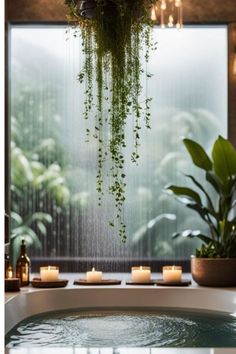 a bathtub with candles and plants hanging from the ceiling