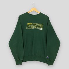 Vintage Champion Green Bay Packers NFL Sweatshirts XLarge Green Bay Packers Embroidered Sweater Packers American Football Crewneck Size XL Good Used Condition. Have several stains, REFER PICTURES.  Size (On Tag) : Size XL **To make sure if it FITS YOU, refer at the exact measurements. Size Measurement (All measurements were taken lying flat) : Width [armpit to armpit] : 24.5 inch / 62 cm Length [shoulder to end of garment] : 26.5 inch / 67 cm THIS IS USED CLOTHING! PLEASE DON`T EXPECTED IT TO BE Green Long Sleeve Top With Embroidered Logo, Green Long Sleeve Fan Apparel Top, Green Long Sleeve Sweatshirt With Embroidered Graphics, Green Embroidered Tops For Winter, Winter College Tops With Embroidered Logo, Green Top With Letter Embroidery For Streetwear, Green Embroidered Crew Top, Green Embroidered Crew Neck Top, Green Letter Embroidery Top For Streetwear