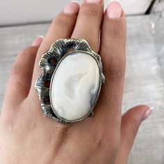 Large white agate ring Sterling silver, Druzy agate geode rings for women, Big ring asymmetric, white gemstone ring made in Armenia A huge and large ring in sterling silver 925 for women. The ring`s stone is natural druzy agate. One of a kind ring for unique women) The ring is absolutely handmade. All our jewelry is crafted with great attention to detail! We strive to provide you the best quality, modern design, and perfect look!! All our jewelry is made of high-quality sterling silver and is st White Ethical Gemstone Rings For Gift, Modern White Crystal Ring Gift, Modern White Opal Gemstone Ring, Modern White Opal Ring, White Cabochon Moonstone Ring In Fine Jewelry Style, Fine Jewelry White Cabochon Moonstone Ring, White Cabochon Moonstone Ring Fine Jewelry, White Moonstone Open Ring, Adjustable Elegant White Opal Ring