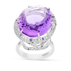 Exuding pure elegance, you'll stand out in a crowd with this romantic, feminine, luxurious designer jewelry piece. This stunning cocktail ring is crafted in 18K white gold,  showcasing an oval royal purple amethyst mounted in a six prong setting and wrapped in a gorgeous embellished diamond pave halo. The center stone sits on a white gold band in a cathedral setting featuring sparkling miniature diamond adorned filigree detailing. Surprise your loved Luxury Hallmarked Amethyst Ring For Formal Occasions, Luxury Purple Jewelry With Halo Detail, Luxury High Luster Purple Jewelry, Luxury Purple Rose Cut Diamond Jewelry, Luxury Purple Platinum Rings, Luxury Amethyst Ring With Prong Setting, Exquisite Amethyst Ring With Gemstone Accents For Formal Occasions, Luxury White Gold Amethyst Ring With Gemstone Accents, Luxury White Gold Amethyst Ring With Diamond