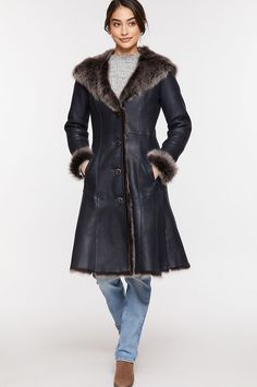 We fashioned winter warmth into a long, elegant coat that surrounds you in elegance. The Theodora, crafted from premium Spanish Toscana sheepskin, boasts a navy brisa exterior and plush interior. Feel the luxuriousness and loft of Toscana sheepskin at the hemline, cuffs, collar, and generously sized hood and enjoy the supreme insulation it offers. Nicely shaped with a defined waistline and feminine flared hem, this warm, button-front coat makes a grand showing wherever you wear it. With two fron Elegant Coats, Sheepskin Coat, The Supreme, Insulation, Fur Coat, Winter Fashion, Winter Jackets, Loft, Exterior