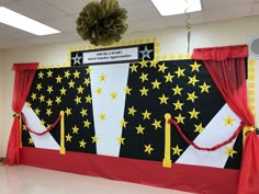 a decorated stage with red curtains and yellow stars