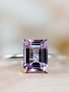 This classic solitaire setting contains a beautiful 2.5ct natural Rose De France amethyst. The emerald cut stone measures approximately 9x7mm and the band is 2mm wide. The ring is available in sterling silver, and 14k white, yellow, or rose gold.  This ring makes a unique promise or engagement ring.  Please send me a message if you need a size not listed.  *  This ring can be customized with any color center stone. All items are handmade by me in my shop in Manalapan, NJ.  Please message me with Luxury Lavender Amethyst Ring Elegant Style, Luxury Faceted Amethyst Ring In Fine Jewelry Style, Luxury Fine Jewelry Silver Amethyst Ring, Luxury Classic Amethyst Ring With Gemstone Accents, Luxury Modern Amethyst Ring With Diamond, Amethyst Engagement Ring White Gold, Emerald Cut Amethyst Ring, Lavender Amethyst Engagement Ring, Amythest Engagement Rings