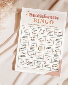 a bachelor party game is shown on top of a bed with pink and white sheets