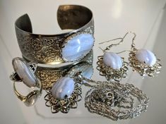 "This is a very special set of Vintage Blue Lace Agate Silver jewelry. The earrings, necklace, and ring are stamped, \"Sterling.\" The bracelet is possibly Silver-plated steel. The Ellensburg Blue is of fine quality, and has a pleasant Robin's Egg Blue hue to it. When you look at it in direct Sunlight, it is wonderfully Peachy Pink in color. The dichroic effect is quite beautiful! Each piece is perfectly matched, and quite elegant. It is an heirloom piece, and must be sold as a set. (As requeste Blue Jewelry Set, Demantoid Garnet, Robin's Egg Blue, Agate Jewelry, Robins Egg Blue, Agate Ring, Royal Jewelry, Blue Jewelry, Blue Lace Agate