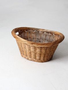 a wicker basket sitting on a white surface