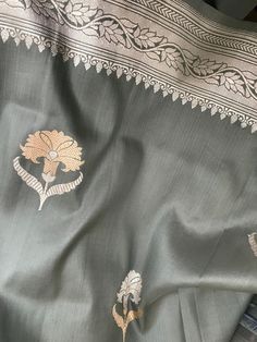 This is an exquisite katan banarasi silk saree in steel gray with beautiful kadua sona rupa motis in body and floral silver zari motifs in borders and beautiful grand zari pallu. Blouse piece is unstitched with silver zari borders. Colour may vary slightly depending upon lighting and individual device settings. Handloom products may have some irregularities  Dry clean only  All sales are final  Falls and pico are done Katan Silk Saree Banarasi, Silk Saree Banarasi, Shade Card, Saree Banarasi, Katan Silk Saree, Banarasi Silk Saree, Saree Border, Katan Silk, Gray Silk