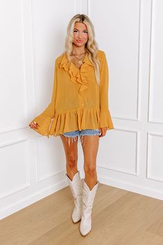 - Show your unique style with this flowy top! - Unlined sheer material with a subtle texture - A ruffled v-cut neckline - A button-up front - Long bell sleeves with cuff button detail - A relaxed silhouette that ends in a ruffle hemline Measurements S : Bust 44", Hip 48", Length 28", Sleeve Length 25", Waist 46". M : Bust 46", Hip 50", Length 28", Sleeve Length 25.5", Waist 48". L : Bust 48", Hip 52", Length 28.5", Sleeve Length 25.5", Waist 50". Flowy Yellow Blouse For Fall, Yellow V-neck Ruffle Blouse, Flowy Ruffle Hem Blouse For Fall, Yellow Flowy V-neck Blouse, Sheer Material, Relaxed Jeans, Flowy Tops, V Cuts, Women Clothing Boutique