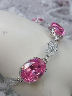 Rhodium plated sterling silver bracelet with pink CZ oval gemstones and Edwardian detailed filigree Elegant Oval Bracelets For Party, Dazzling Oval Bracelets For Formal Occasions, Pink Crystal Bracelet For Formal Occasions, Pink Crystal Bracelets For Formal Occasions, Oval Diamond Party Jewelry, Pink Oval Cubic Zirconia Jewelry, Formal Pink Crystal Bracelet, Oval Jewelry With Sparkling Stones For Party, Elegant Oval Crystal Bracelet