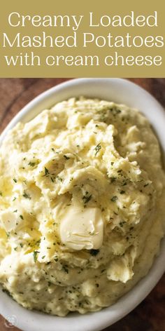 creamy loaded mashed potatoes with cream cheese in a white bowl on a wooden table