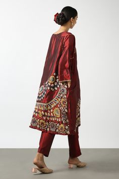 Maroon two tone kurta with kalamkari floral applique embroidery and side slits. Paired with pant.
Components: 2
Pattern: Embroidered
Type Of Work: Applique
Neckline: Notched
Sleeve Type: Full
Fabric: Two Tone Silk
Color: Maroon
Other Details: 
Side slits
Pocket detailing
Disclaimer: While the designer strives to recreate every piece as close to what is displayed on the website, there may be subtle variations in color and design. If you have any concerns about the textile, kindly contact the cust Kalamkari Kurta, Embroidery Print, Linen Bottoms, 2 Piece Outfit, Silk Bottoms, Luxury Wear, Fashion App, Fabric Silk, Red Shirt