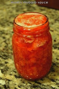 a jar filled with red liquid sitting on top of a counter