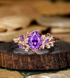 a purple ring sitting on top of a piece of wood