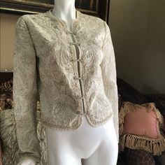 Brand New, Never Worn, No Tags. Elie Tahari Embroidered Cropped Mandarin Collar Intricate Blazer Jacket. Slightly Cropped Length. Stunningly Intricate Embroidery, All Hand Done. Lightweight And Elegant. Colors Are Off White Cream Ivory Colored Base With Light Tan Embroidery. 100% Cotton. Hook And Eye Closures Down Front. Size S. Elegant Fall Outerwear With Gold Embroidery, Elegant Long Sleeve Outerwear With Gold Embroidery, Silk Outerwear With Intricate Embroidery, Elegant Silk Outerwear With Floral Embroidery, Elegant Embroidered Spring Outerwear, Elegant Fitted Outerwear With Intricate Embroidery, Elegant Fitted Outerwear With Gold Embroidery, Elegant Silk Outerwear With Embroidery, Elegant Embroidered Silk Outerwear