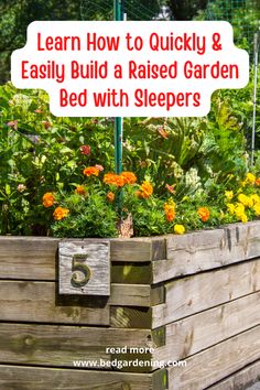 a raised garden bed with sleepers and flowers in the background, text overlay reads learn how to quickly & easily build a raised garden bed with sleepers