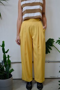 "Vintage Eighties \"Mr. Jax\" Buttercup Yellow High Waisted Trousers. Wide Leg. Pleated. Two Side Pockets. Lined. Wrap-Over Button Closure at Waist. 100% Wool Tag Size 8  Excellent Vintage Condition Waist-26\" Hips-50\" Rise-14\" Inseam-29\" All Sales Are Final. We have taken the time to note all size measurements and the condition of each piece so please look over all the information of the garment you are considering purchasing. Please note that all items are sold in \"Vintage Condition\". If Yellow Office Bottoms For Summer, Yellow Summer Office Bottoms, Casual Yellow Bottoms For Office, Yellow Bottoms For Office Spring Season, Yellow Formal Bottoms For Spring, Formal Yellow Bottoms For Spring, Formal Summer Bottoms With Buttons, Classic Yellow Bottoms For Summer, Yellow Summer Bottoms With Button Closure