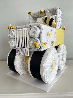 a cake made to look like a construction vehicle with wheels and bees on the front