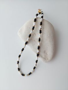 Black white necklace/ Gemstones necklace/ Small beads necklace/ Simple Necklace aesthetic/ Choker necklace/ Casual necklace/ Gift for sister Very beautiful choker made of natural gemstones seed beads (black agate and white howlite 2x4 mm) and gold colour hematite beads . Hematite, unlike metal, remains shiny for a long time and is not subject to oxidation. CARE 1. Try not to drop the choker, otherwise the beads may break. 2. Do not swim in the sea, take a bath in this choker. 3. It will be good if your choker does not come into contact with cosmetics and perfume. 4. Take it off at night to minimize the risk of breaking the chain DELIVERY: Usually delivery to EU countries is about 7-12 days. To the USA and other countries - from 12 to 20 days Adjustable White Beaded Necklace With Natural Stones, Everyday White Beaded Necklaces, Everyday White Single Strand Beaded Necklace, Everyday Adjustable White Necklaces, Everyday Adjustable White Necklace, White Crystal Choker Necklace For Gift, Everyday White Single Strand Necklace, White Round Beads Crystal Necklace Minimalist Style, Adjustable White Gemstone Bead Necklaces