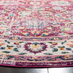 a pink rug with colorful flowers on it