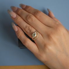 a woman's hand with a ring on it