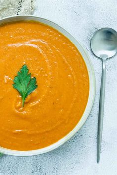 A bowl of tomato lentil soup topped with parsley on a white surface. Comfort Pasta, Lentil Soup Recipe, Plant Based Soups