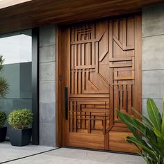 a large wooden door sitting next to a plant