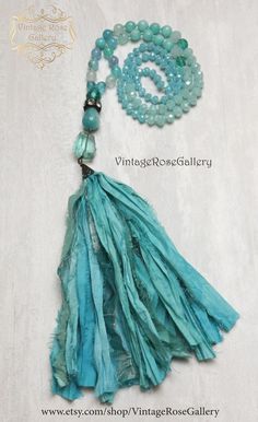 Sari Silk Tassel  Necklace, Aqua Silk Tassel Necklace, Turquoise Agate Jade  Boho Chic Necklace, Statement Necklace ''Mermaid Necklaces " A gorgeous hand made  Sari silk tassel Turquoise Necklace . Features antique rhinestones,  beautiful light blue  Agate gemstones 8mm ,  a large Aqua Quartz ,  a large jade gemstone,  antique copper findings , Czech glass   and a beautiful hand made Sari Turquoise Silk tassel !!!This necklace is so beautiful ...  It is full of Aqua colours !!! The Agate gemston Turquoise Bohemian Tassel Necklace, Adjustable Turquoise Tassel Necklace For Gift, Turquoise Beaded Tassel Necklace Gift, Turquoise Tassel Necklaces For Festivals, Turquoise Tassel Necklace For Beach, Turquoise Beaded Necklaces With Tassels For Gift, Turquoise Jewelry With Tassels And Round Beads, Adjustable Turquoise Tassel Necklace With Round Beads, Turquoise Beaded Necklace With Tassels, Bohemian Style