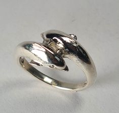 **Please note that we dispatch on Tuesdays unless special delivery express option is paid for** Sterling silver Dolphin crossover ring. Original design carved in wax then lost wax cast into solid sterling silver.  Handmde in London.  Available in ring sizes A-Z6. First class post included. Dolphin Ring, Wax Ring, Crossover Ring, Special Delivery, Lost Wax, Ring Sizes, Sterling Silber, Dolphins, Handmade Silver