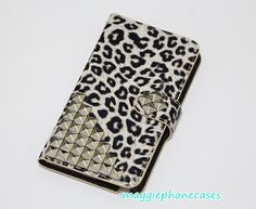 an animal print wallet with rivets on it