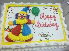 a birthday cake with a clown holding a balloon