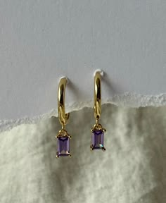 Lilac/Purple Zircon Gem stone Earring Hoops Made to be worn alone all also to stacked.  This stunning earrings are hypoallergenic (lead and nickel free).  Perfect for everyday wear as they are Tarnish resist and waterproof,  Hoop diameter : 10mm Earrings are sold individually or as a pair and are available in Sterling silver and 18k gold plated. Made with 18K goldplated and sterling silver.  They are light weight. Easy to wear. Tarnish resist and sweat/waterproof, perfect for everyday wear.  All Purple Stone Jewellery, Purple Energy, Rectangle Hoop Earrings, Piercing Inspo, Earring Hoops, Purple Earrings, Purple Stones, Purple Lilac, Lilac Purple