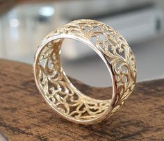 a gold ring sitting on top of a wooden table