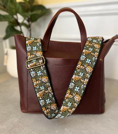 "Update and refresh your bags with this lovely floral embroidered purse strap in colors of green, blue, pink and black.  Straps can come in antique brass / bronze, gold or silver hardware to perfectly match your bag and style.  Strap is 2\" wide and has an adjustable length from 30.5\"-55\" (including hardware) ~contact me if you would like a custom length~ These replacement guitar straps for handbags are made with high-quality durable metal buckles and premium woven material Whether you are heading to a music festival, a night out on the town, or just running errands, this embroidered guitar style crossbody purse strap is the perfect addition to your accessory collection. It is not only fashionable but also functional and versatile, making it an ideal choice for any occasion." Trendy Green Bag Strap For Everyday, Trendy Green Everyday Bag Strap, Detachable Strap Bag Strap For Everyday Use In Spring, Adjustable Leather Handle Crossbody Shoulder Strap, Adjustable Leather Crossbody Strap With Handles, Adjustable Bag Strap With Leather Handles For Daily Use, Adjustable Green Bag Strap For Everyday, Green Adjustable Strap For Bags, Green Adjustable Everyday Bag Strap