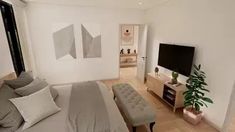 a bedroom with a bed, television and couch in it's centerpieces