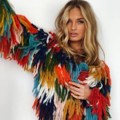 a woman in a colorful jacket posing for the camera