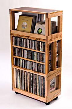 a wooden shelf filled with lots of different types of music and cds on it's sides